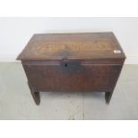 An 18th century and later oak coffer of small proportions, 43cm tall x 54cm x 31cm, some old repairs