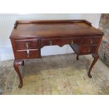 A circa 1930's walnut 5 drawer desk / side table with floating gallery on carved cabriole legs, 84cm