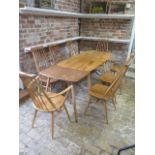 A blonde elm Ercol dining table, 71cm tall x 152cm x 75cm with separate extension which extends it