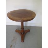 A Victorian rosewood tilt top side table on a turned column and tripartite platform base, 61cm