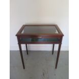 A mahogany bijouterie display table with felt interior on tapering legs, 77cm tall x 68cm x 45cm, in