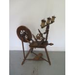 A 19th century spinning wheel with triple gallery