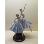 A Lladro group of two ballerinas on a wooden stand 'Merry Ballet' no 5035, 49cm tall, in good