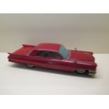 A Japanese tinplate friction drive Cadillac car, 43cm long, drive works, some wear and broken rear