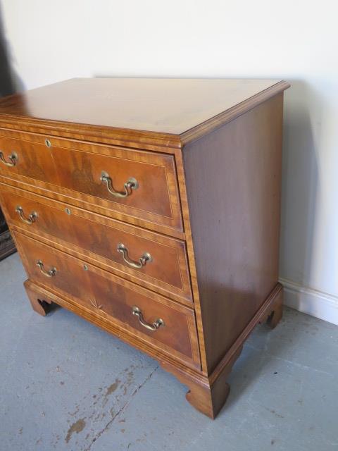 A reveneered 3 drawer chest with star inlay, standing on shaped bracket feet, 90cm tall x 95cm x - Image 3 of 5