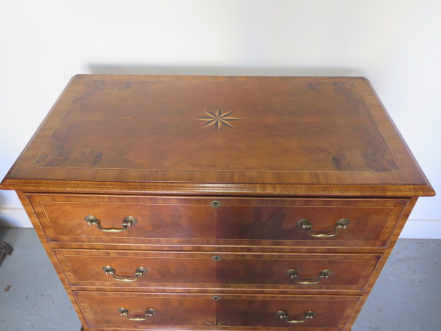 A reveneered 3 drawer chest with star inlay, standing on shaped bracket feet, 90cm tall x 95cm x - Image 2 of 5