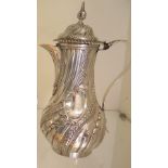 A white metal embossed jug with makers mark WT to base, 28cm tall, approx 26.9 troy oz, some
