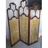 A 19th century mahogany ornate salon three fold vanity screen with silk linings and glazed top,