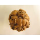 An Oriental wooden well carved ball depicting Siberian tigers, 7cm wide, in generally good condition