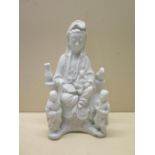 A Chinese 19th century blanc-de-chine porcelain incense burner of Guanyin with two attendants