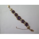 A 9ct yellow gold hallmarked amethyst bracelet, 17cm long, approx 27.8 grams, safety chain loose and