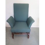A mahogany upholstered armchair on turned supports and stretchers, has been recovered at some stage,