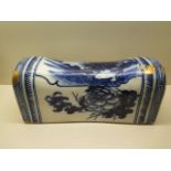 A Chinese late 18th / early 19th century blue and white pottery head rest decorated with a landscape