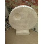 A circular abstract garden sculpture, carved in Clipsham limestone by a Cambridgeshire based stone