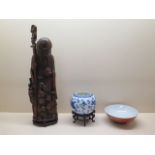 An Oriental carved Bamboo/wooden figure on stand, 47cm tall, and a blue and white dragon pot on stan