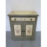 A decorated cabinet with a drawer above two cupboard doors, 80cm tall x 72cm x 37cm