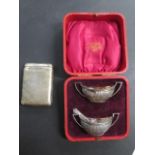 An unusual silver cigarette case, two boxed silver salts with a spoon, total weight approx 4 troy oz