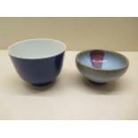 An Oriental earthern ware Chinese footed bowl, 4cm x 8cm, and a blue case footed cup, both generally