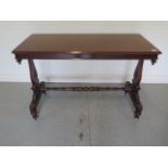 A Victorian mahogany stretcher table with shaped twin pedestal supports united by a turned