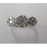 An 18ct flower head diamond cluster ring, total 0.75ct diamonds, size M, marked 18ct, diamonds