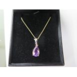 An 18ct yellow gold amethyst trillion cut diamond pendant on an 18ct yellow gold chain, approx 18"
