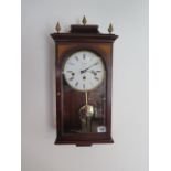 A Comitti London three train chiming wall clock in mahogany case, 53cm tall, in good running order