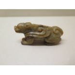 A carved jade recumbent dragon, 7cm long, in good condition