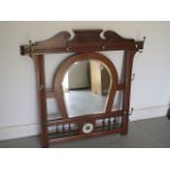 An early 20th century oak framed wall mirror and coat / hat rack with small barometer, 94cm tall x