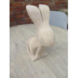 A stylised limestone rabbit sculpture, carved from Clipsham limestone by a Cambridgeshire based
