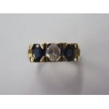 A 14ct yellow gold three stone diamond and sapphire ring, the centre diamond approx 2.5ct, size L,