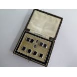 A cased Art Deco gentleman's stud and cufflink set in 9ct white gold and black onyx, with stud