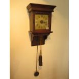 An early 19th century hooded oak wall clock with single hand, brass weight and pendulum with 7"