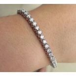 A 14ct white gold diamond tennis bracelet 17.5cm long set with 50 diamonds, each approx 0.10 ct appr