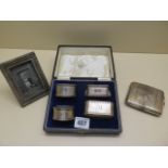 Four silver napkin rings, a silver cigarette case and a silver fronted frame, weighable silver