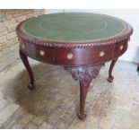 A mahogany 4 drawer drum / library table with a leather inset top on 4 carved shaped legs with