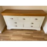 A painted 7 drawer chest, 150cm wide x 77cm high