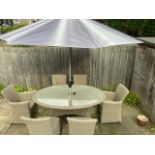 A Bramblecrest Sahara garden table and 6 chairs including 2 armchairs and a parasol and base,