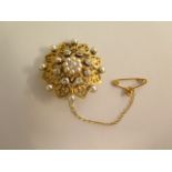 A yellow gold diamond and pearl brooch, 3cm wide, no hallmarks but tests to approx 18ct, in