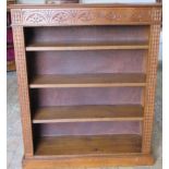 A carved oak bookcase with 3 adjustable shelves, 109cm tall x 92cm x 27cm