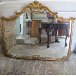 An ornate gilt overmantle modern mirror, 115cm x 136cm