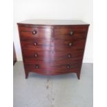 A Georgian mahogany bow fronted chest of 2 over 3 graduated drawers on swept feet and bun handles,