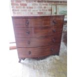 A 19th century mahogany bowfronted five drawer chest on splayed bracket feet united by a carved