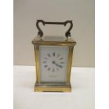 A brass French carriage clock, the dial signed Garrard & Co Ltd, 15cm tall with handle up, with key,