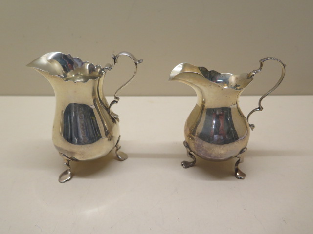 Two silver cream jugs, tallest 10cm, total weight approx 6.1 troy oz, denting to smaller jug and