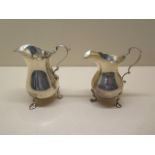 Two silver cream jugs, tallest 10cm, total weight approx 6.1 troy oz, denting to smaller jug and