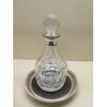 A cut glass decanter with a silver collar, 26cm tall, Birmingham 1991 PHV & Co, and a silver and