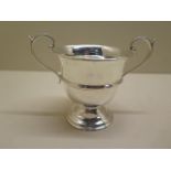 A twin handled loving cup with scroll handles, London rubbed hallmarks, EJH and NH, 9.5cm tall, good