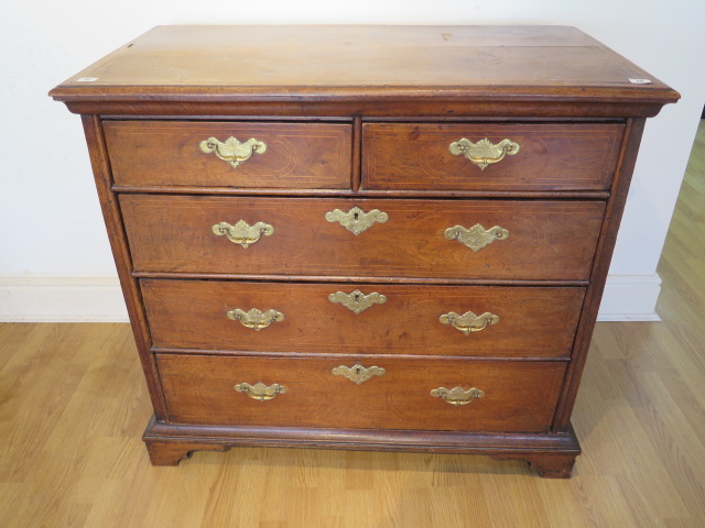 An 18th century line inlaid walnut 5 drawer chest with panelled sides and back on shaped bracket