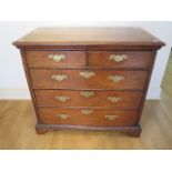 An 18th century line inlaid walnut 5 drawer chest with panelled sides and back on shaped bracket