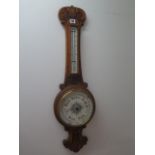 A carved oak aneroid / barometer with thermometer, 86cm tall